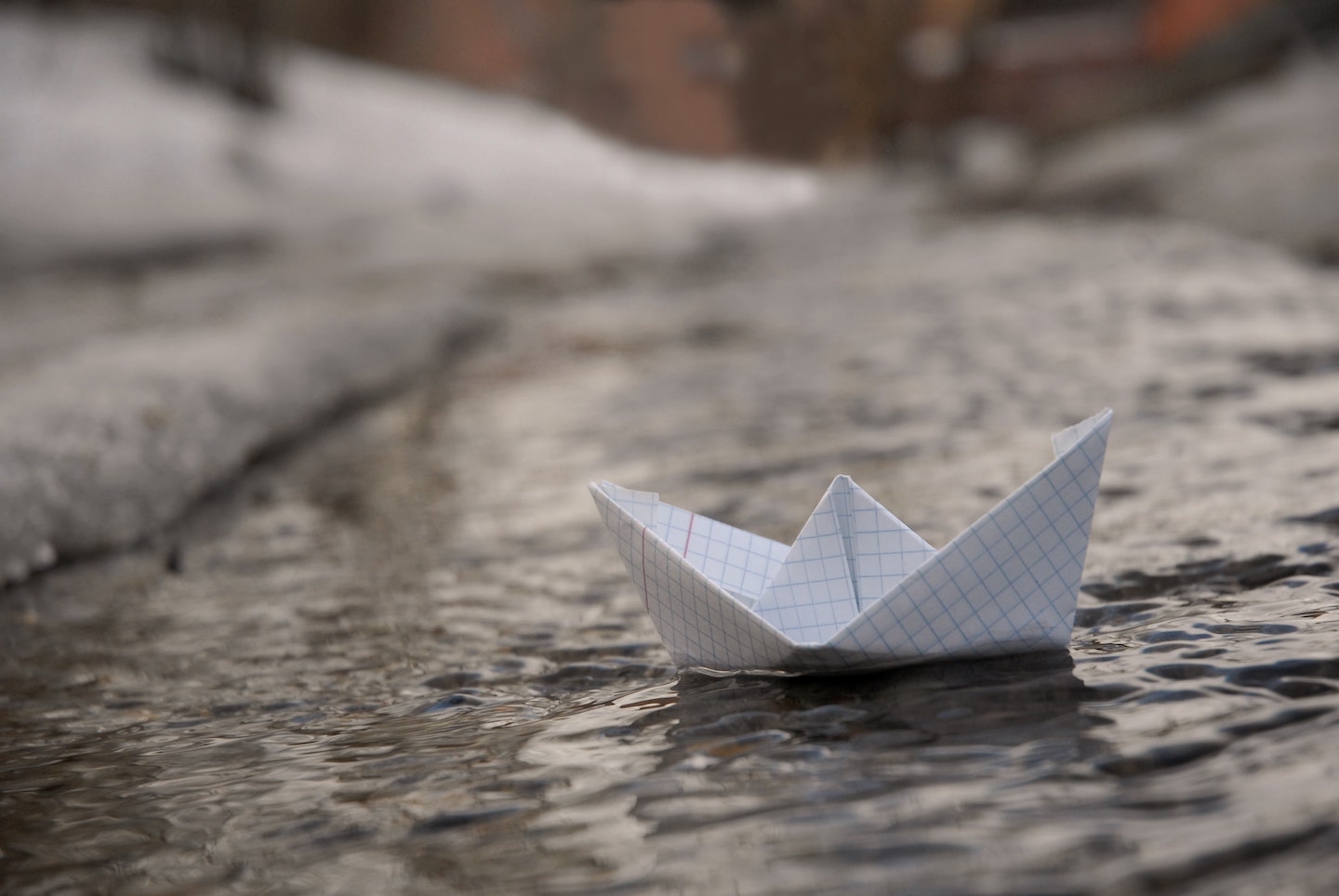 Bateau en papier flottant dans une flaque d’eau