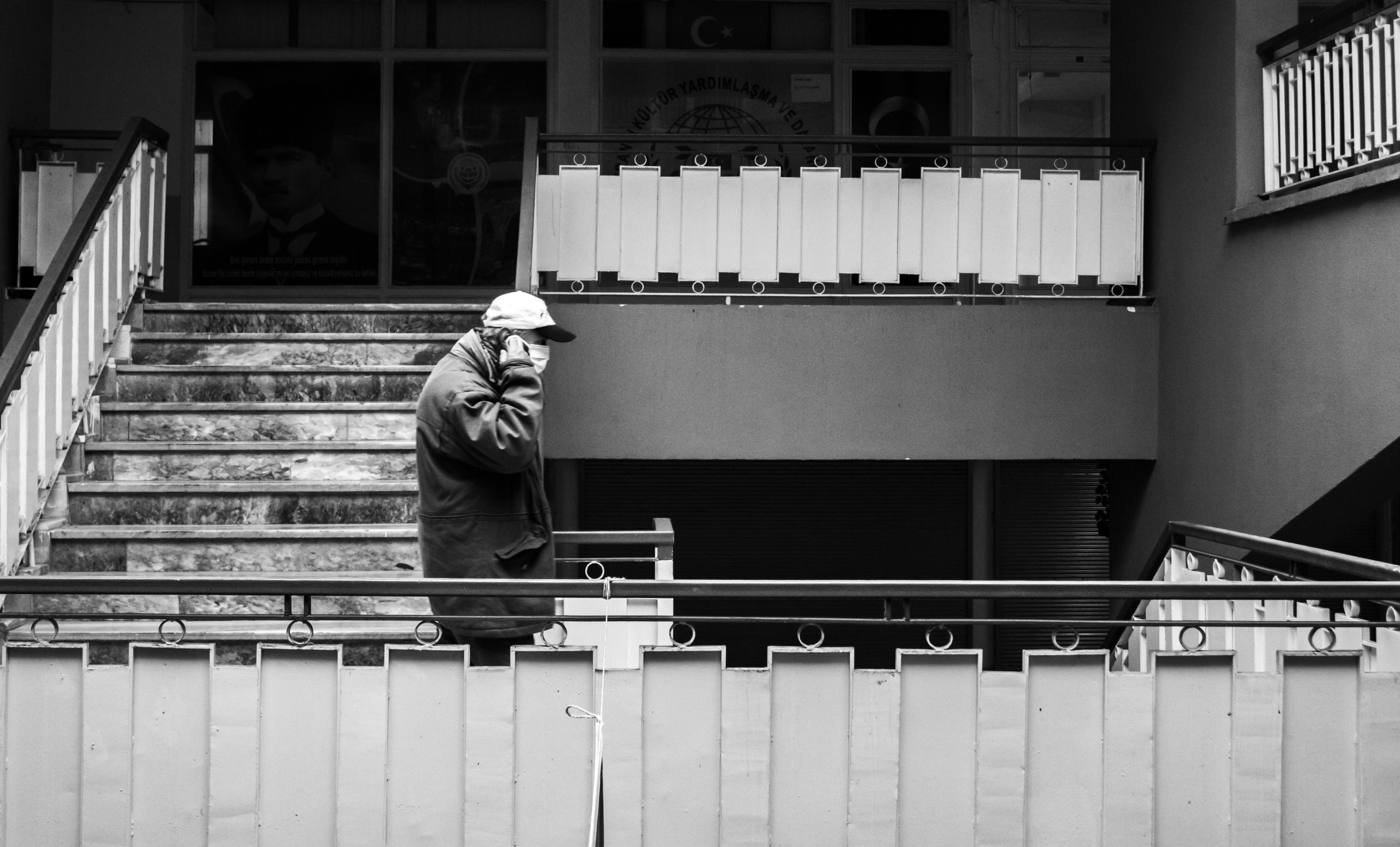 L'image montre un homme portant un masque téléphone au bas d'une tour d'immeuble